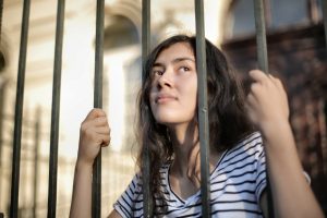 Mujer tras unos barrotes. amarse a uno mismo